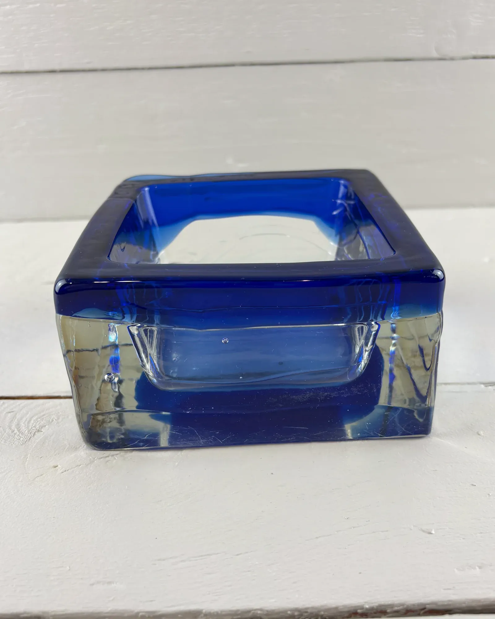 Swedish Sargasso glass bowl by Paul Kedelv for Reijmyre, cobalt blue rim over clear glass, front view
