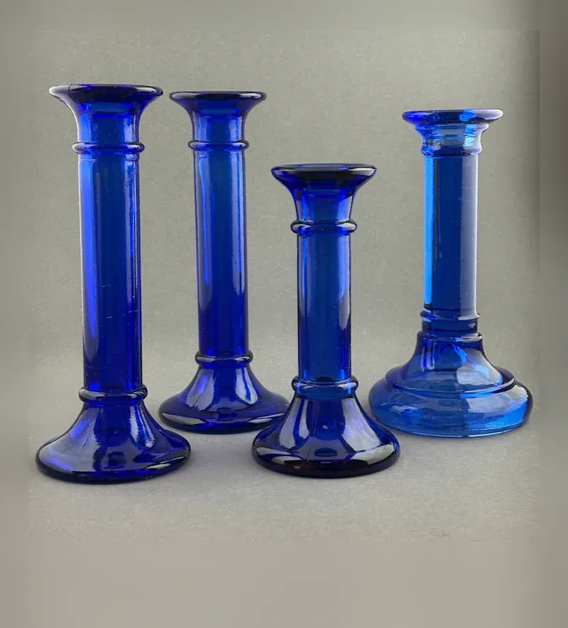 Cobalt blue glass candle holders, a set of four in varying heights