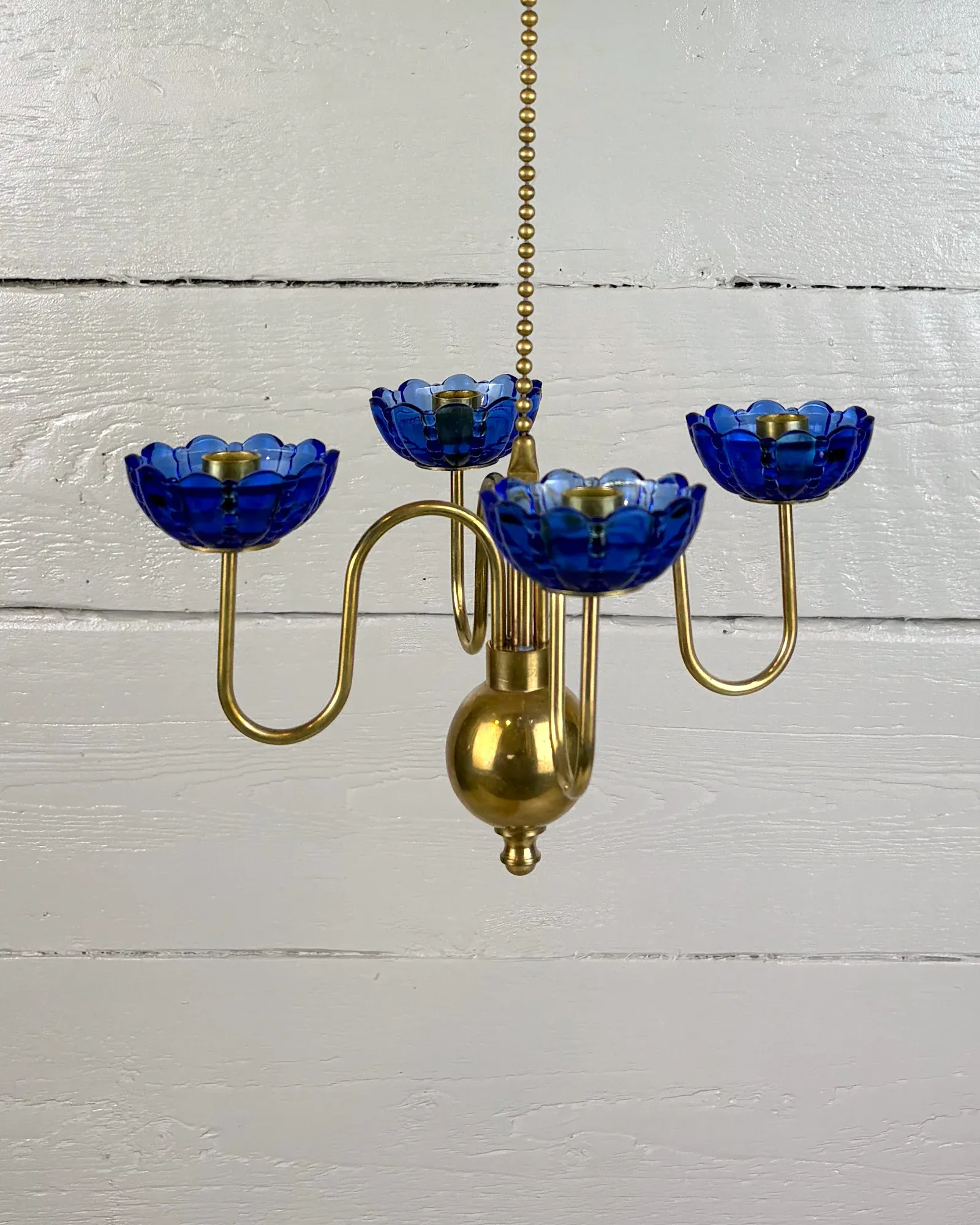 Swedish brass hanging candelabra by Gunnar Ander for Ystad Metall, front view with four blue glass cups