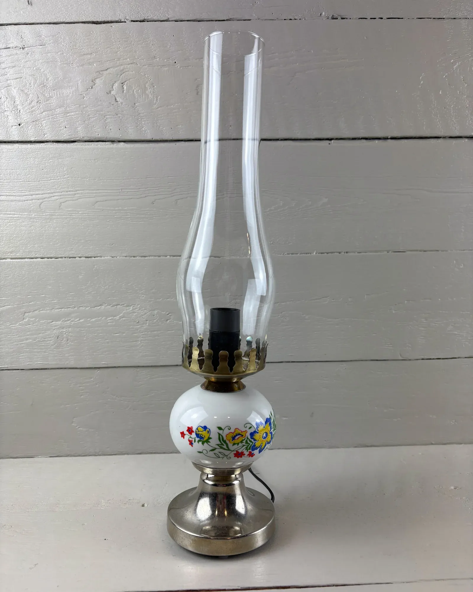 Polam Poznan table lamp, 1980s: glass chimney, brass-toned crown and floral ceramic globe on a metal base