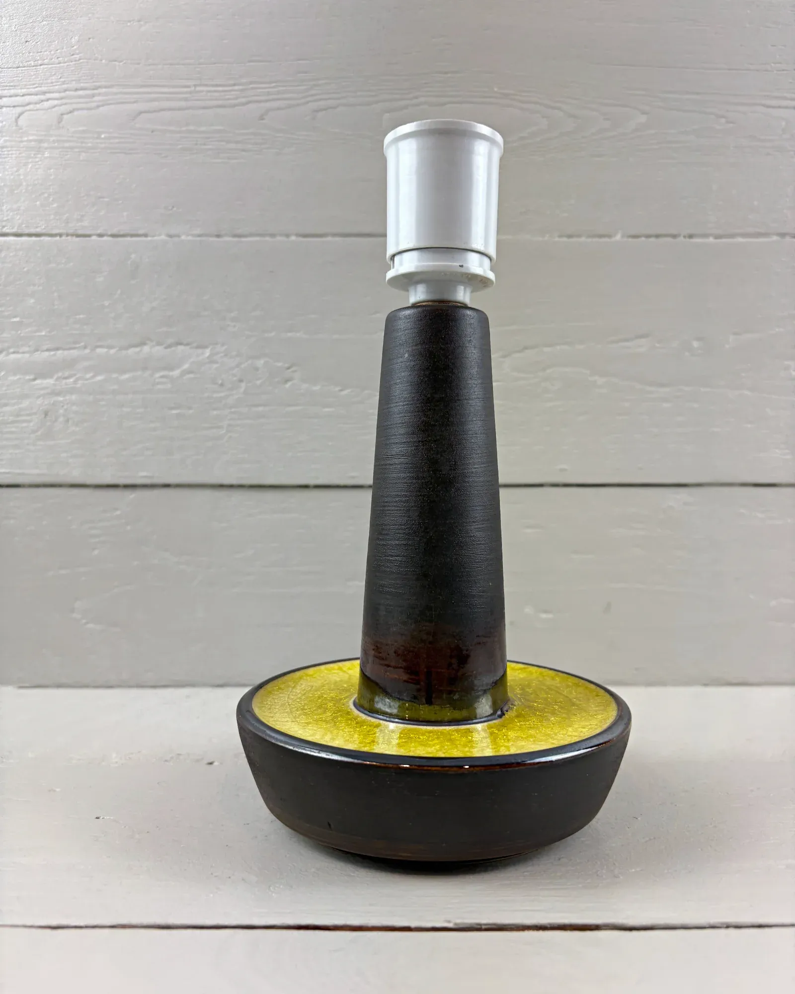 Danish Soholm 1072 stoneware table lamp with dark tapering body and yellow crackle-glazed bowl base, front view