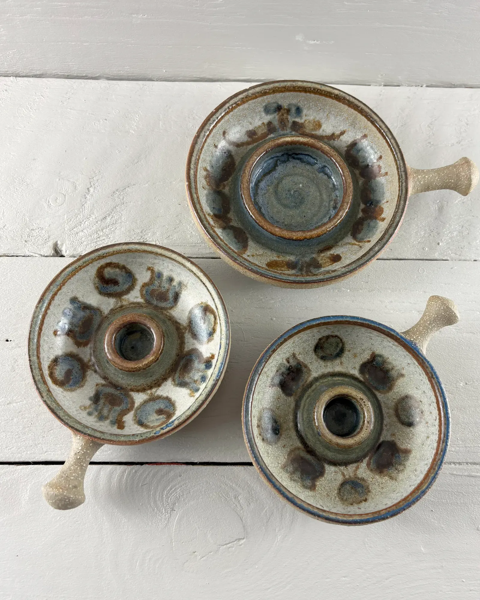 Set of three Soholm stoneware candle holders by Noomi Backhausen, seen from above on white boards