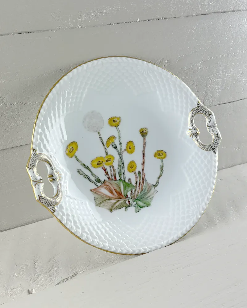 Danish Bing & Grondahl Seagull cake plate at a three-quarter angle, showing the scale relief rim and gold edge