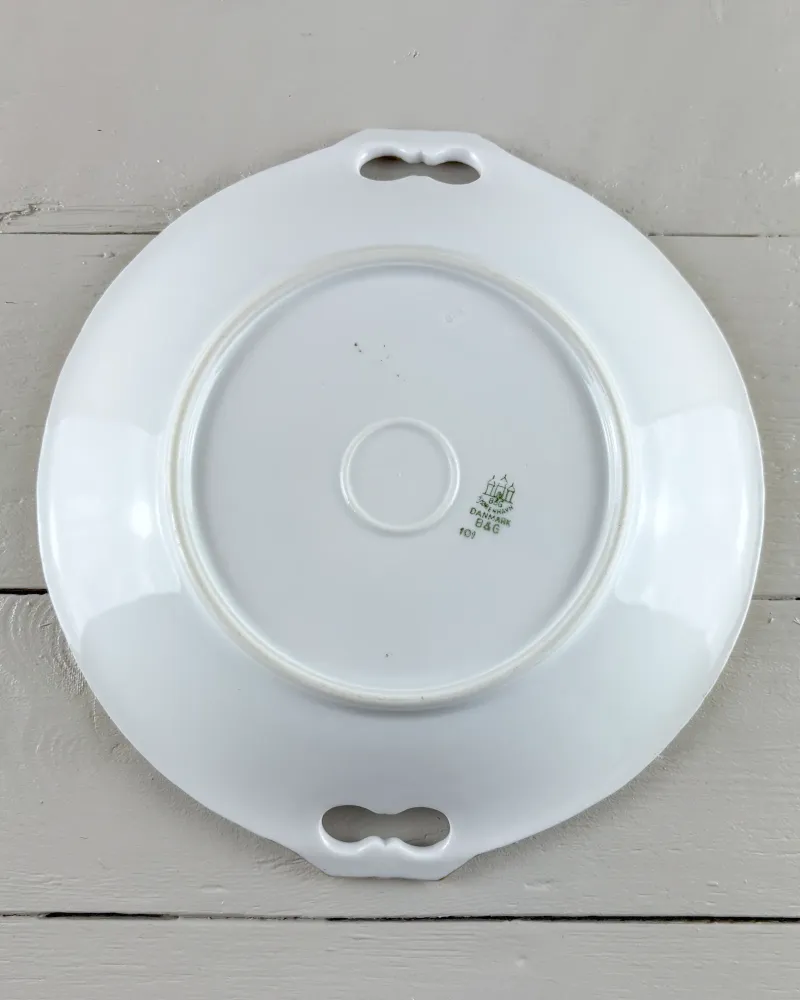 Underside of a Bing & Grondahl porcelain cake plate showing the foot ring and green factory mark