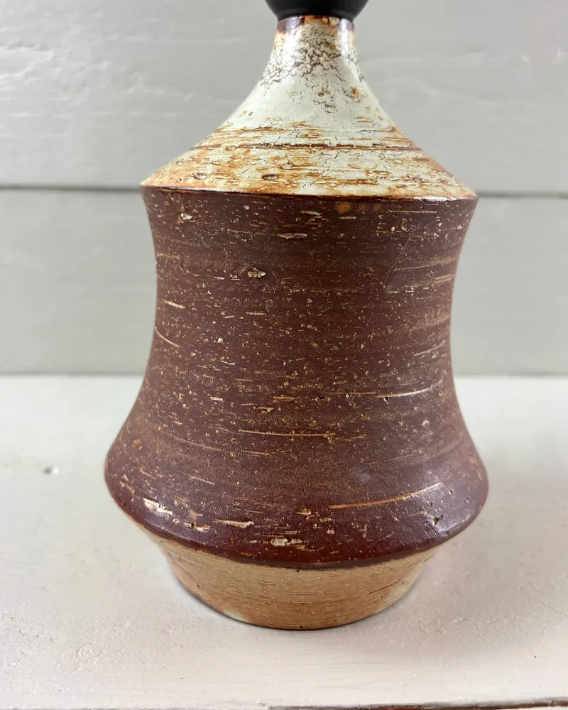 Close-up of the pale mottled glaze with rust-orange edges on the shoulder of a Bo Borgström stoneware lamp