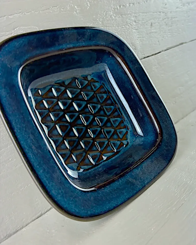 Close-up of the triangle relief in the cobalt blue glaze of an Einar Johansen stoneware bowl for Søholm
