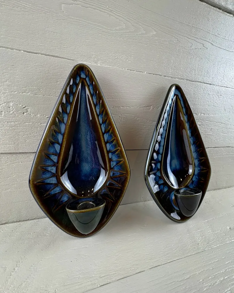 Two Einar Johansen wall candle holders for Soholm seen at an angle, showing the depth of the candle cups