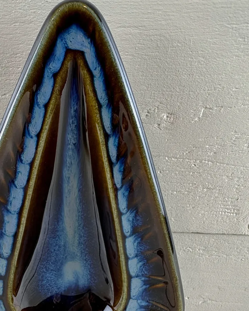 Close-up of the cobalt glaze and light blue incised border on a Soholm 3351 wall candle holder