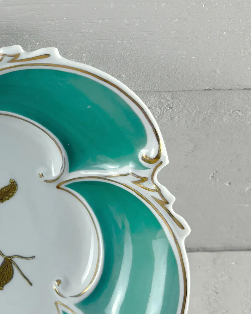 Gold scroll relief on the lobed rim of a turquoise Graf von Henneberg Ilmenau porcelain dish
