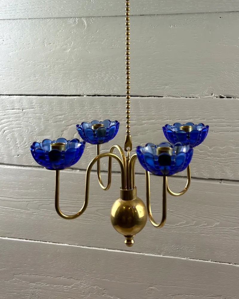 Ystad Metall brass candelabra with four blue glass flower cups and beaded chain, three-quarter view