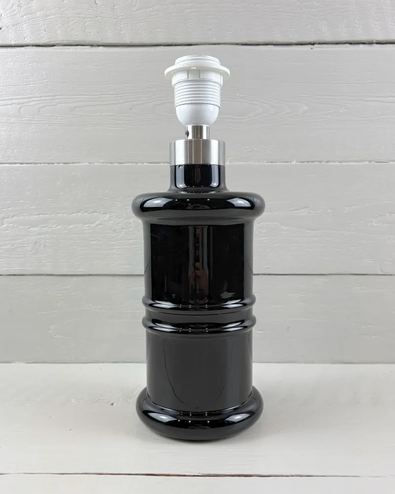 Single Holmegaard Apotheker table lamp in black glass with satin metal collar, no shade, front view