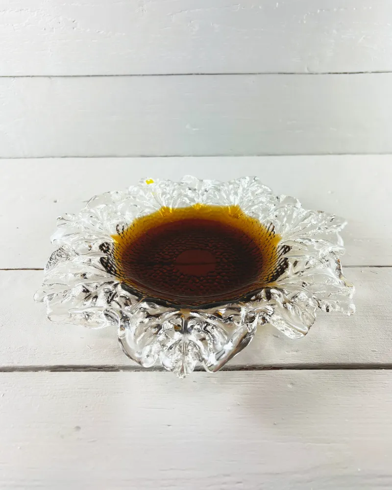 Side view of the Finnish Kasvimaalla glass bowl, low profile with irregular clear leaf rim and dark amber centre