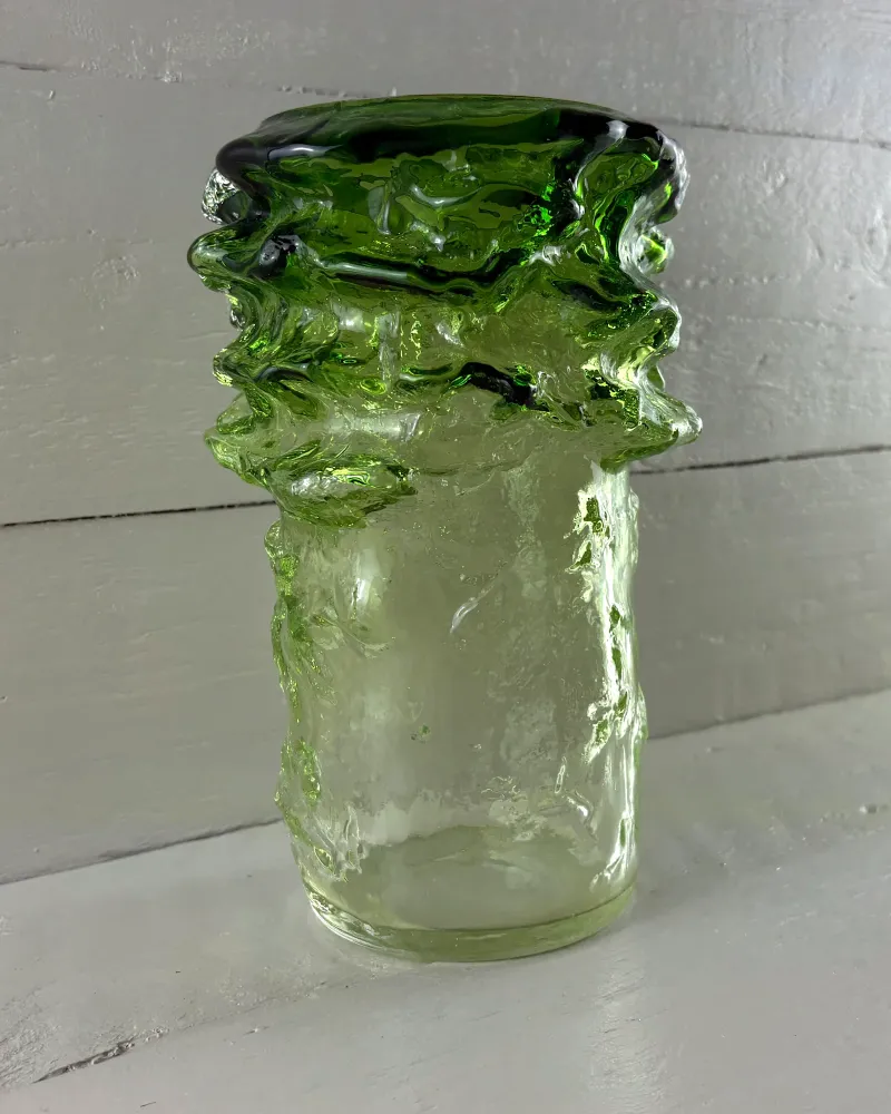 Green glass Pahka vase by Kaj Blomqvist for Kumela, Finland, three-quarter view on white boards