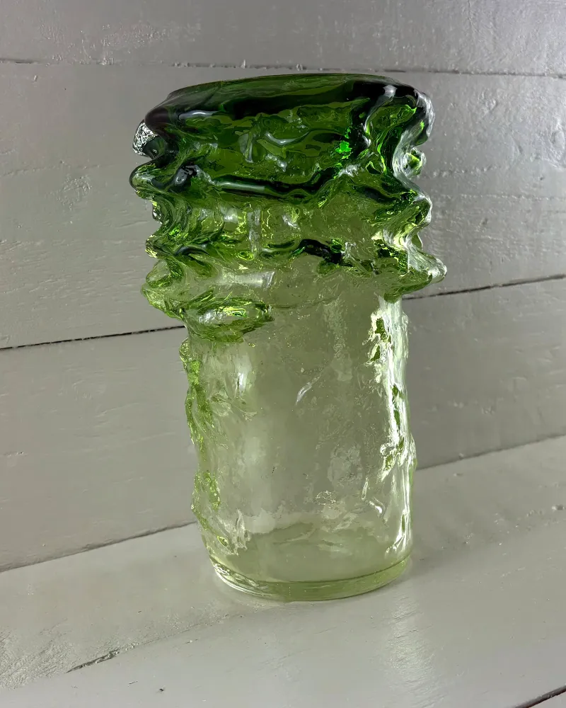 Side view of the Kumela Pahka vase showing the lumpy dark green collar and pale textured body