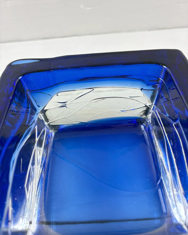Close-up of fine white threads trapped in the cobalt and clear glass of a Kedelv Sargasso bowl