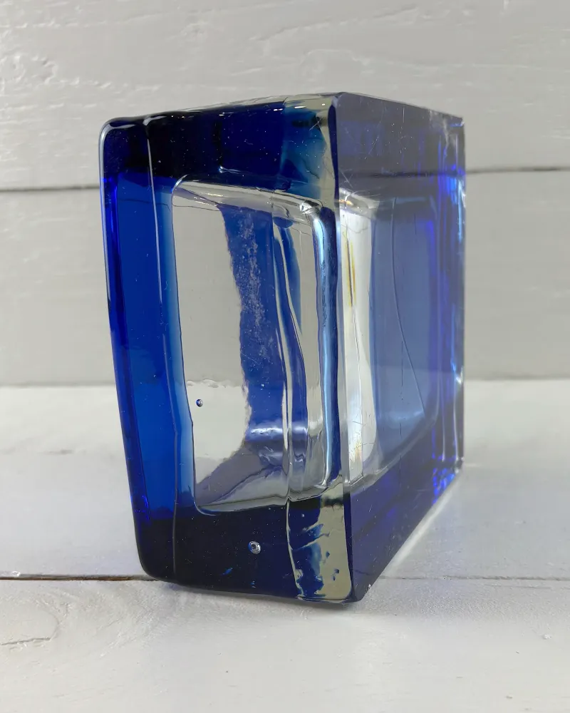 Reijmyre Sargasso bowl turned on its edge, showing the thick cobalt blue and clear glass walls