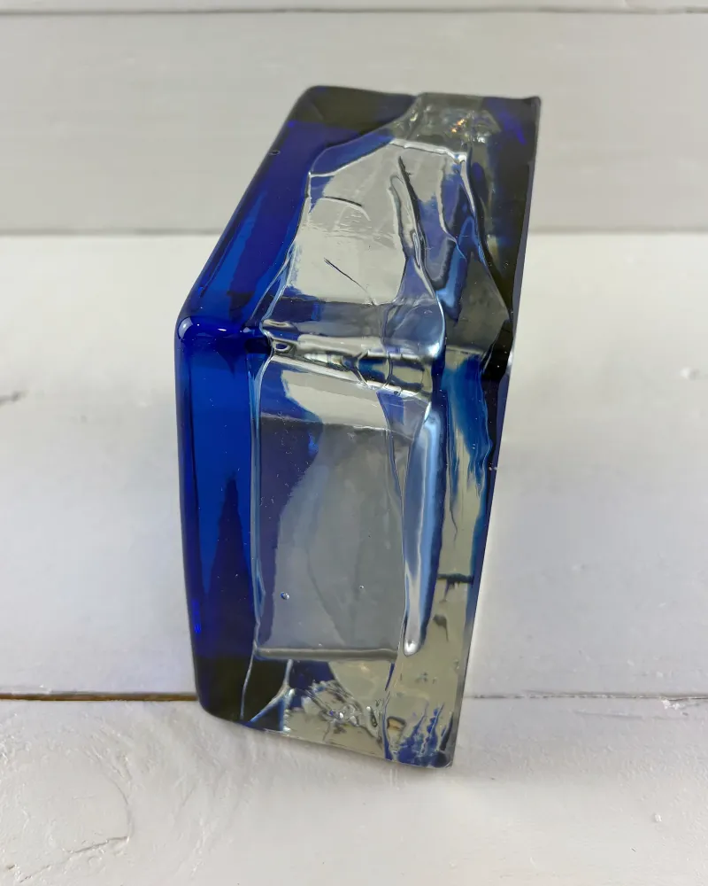Outer wall of a Paul Kedelv Sargasso glass bowl, uneven clear glass framed by cobalt blue edges
