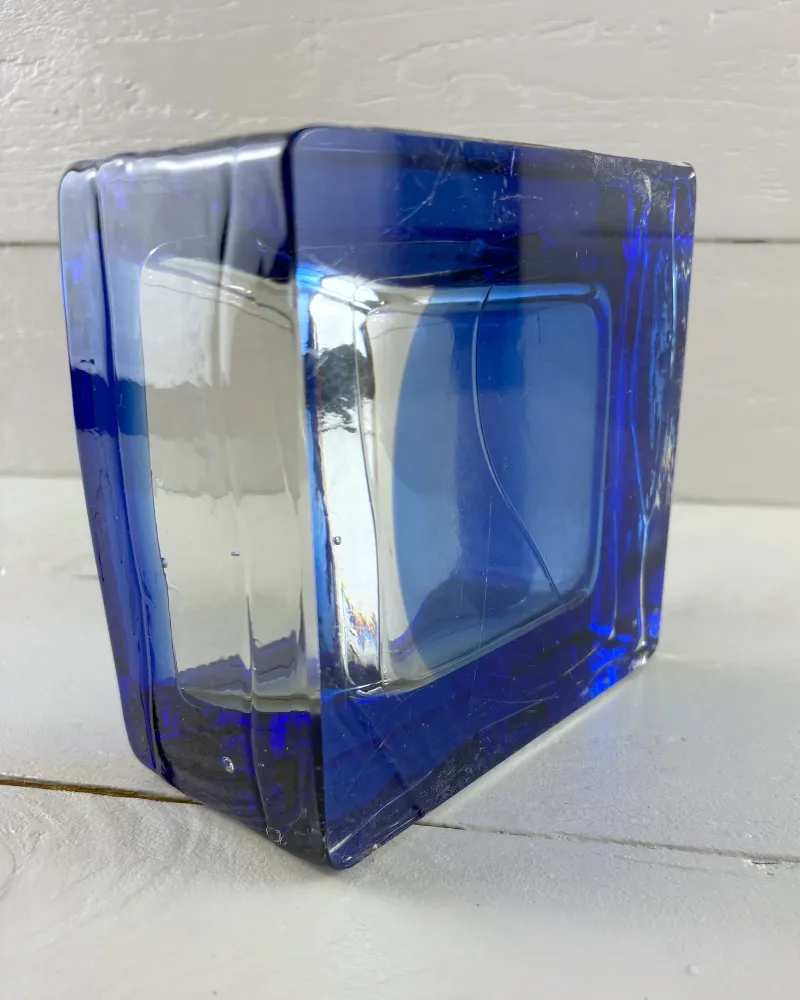 Reijmyre Sargasso bowl on its edge, clear and blue glass wall with fine hairline surface scratches