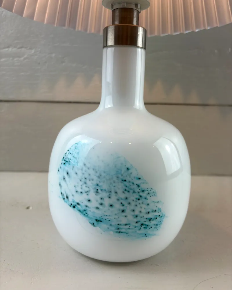 Slender neck of the Holmegaard white opal glass lamp with brushed steel collar and lamp fitting