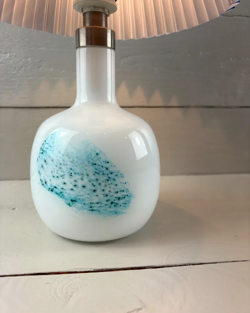 Rounded white opal glass body of the Michael Bang table lamp seen from a low angle, with glossy sheen