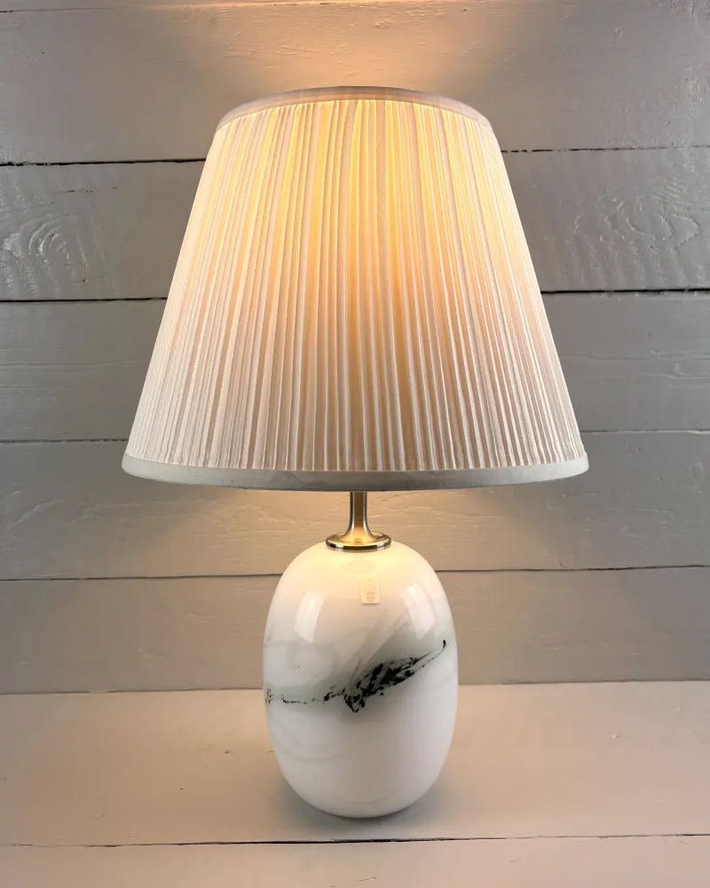 Lit Holmegaard Sakura lamp by Michael Bang with an illustrative cream pleated shade, not included