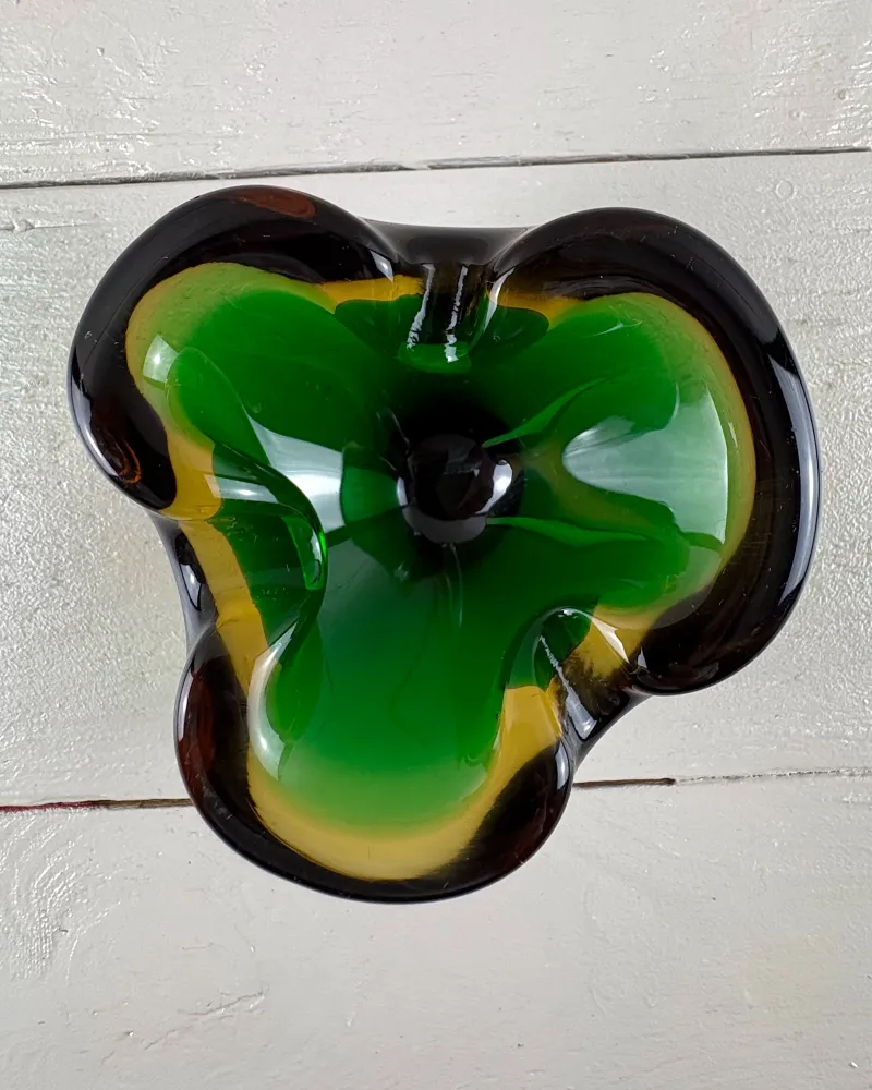 Top view of a Murano-style sommerso glass ashtray showing three lobes and the dark centre of the base