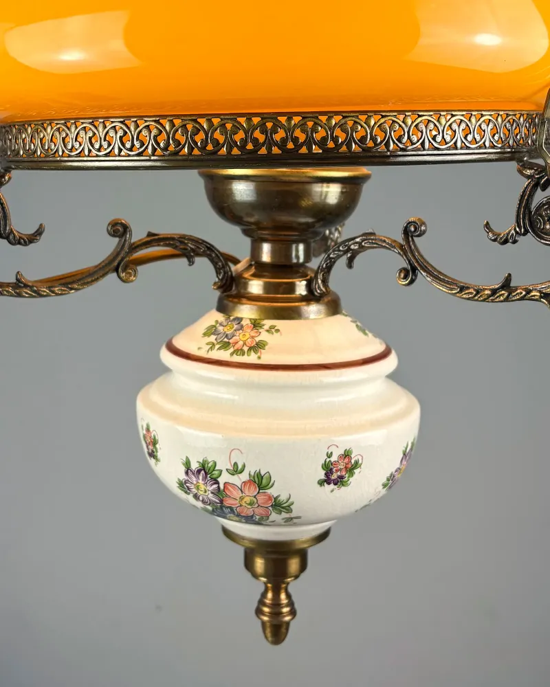 Ivory ceramic font with crackled glaze and floral decoration, brass cap and finial of a vintage pendant lamp