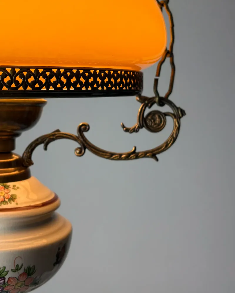 Pierced brass gallery, cast scroll arm and chain link of a vintage oil lamp style pendant light