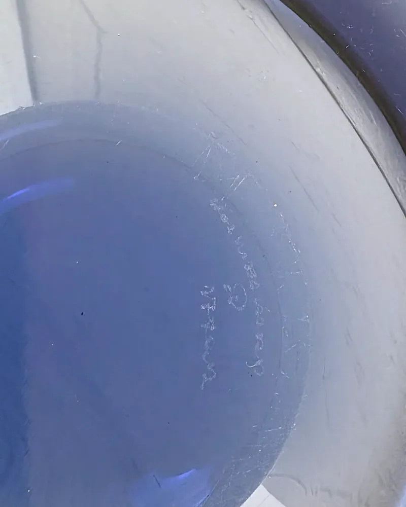 Close-up of the engraved Holmegaard signature on the base of a blue Provence bowl by Per Lütken