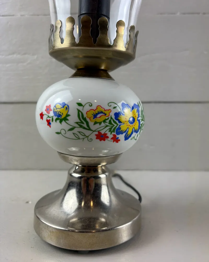 Band of blue, yellow, red and green flowers on the white glazed ceramic globe of a Polam Poznan lamp