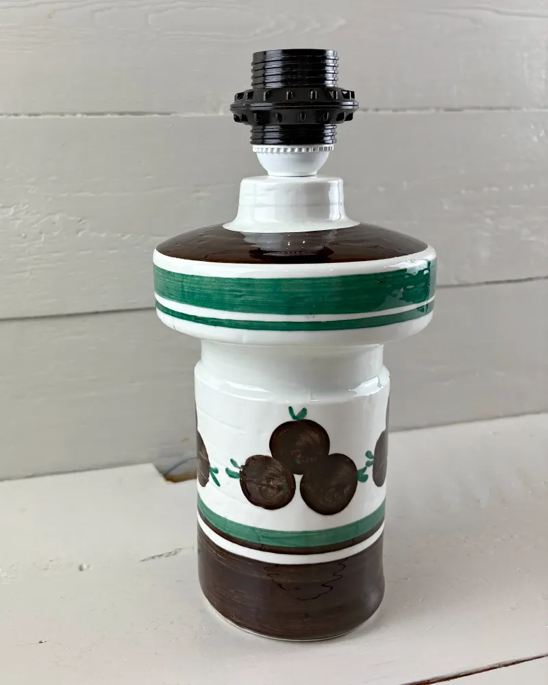 Swedish Rorstrand ceramic lamp base seen from a slight angle, brown fruit decor above a dark brown foot