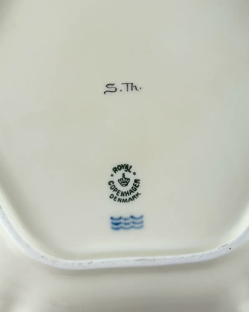 Base of Royal Copenhagen dish with green crown stamp, blue three waves and hand-written S.Th. mark