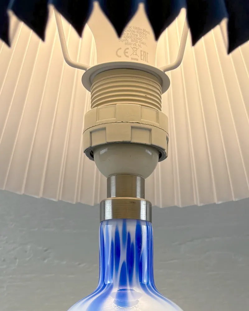 Metal collar and lamp holder of a Royal Copenhagen Torino Lille glass table lamp, seen from below
