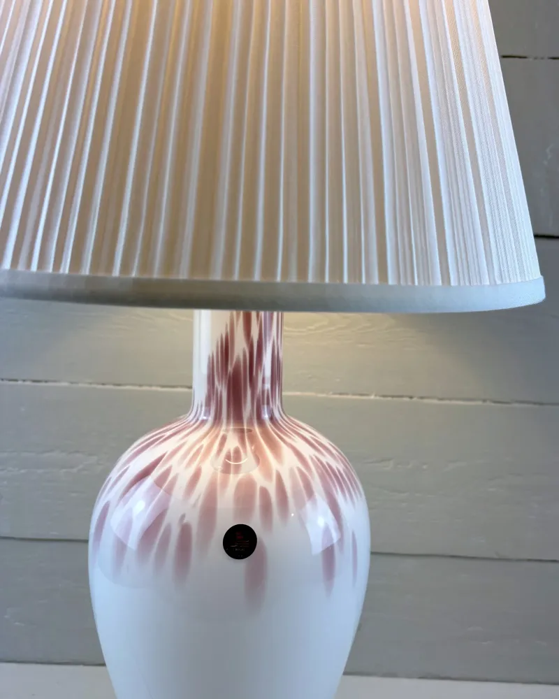 Close-up of pink-mauve streaks on the shoulder and neck of a Michael Bang opal glass lamp