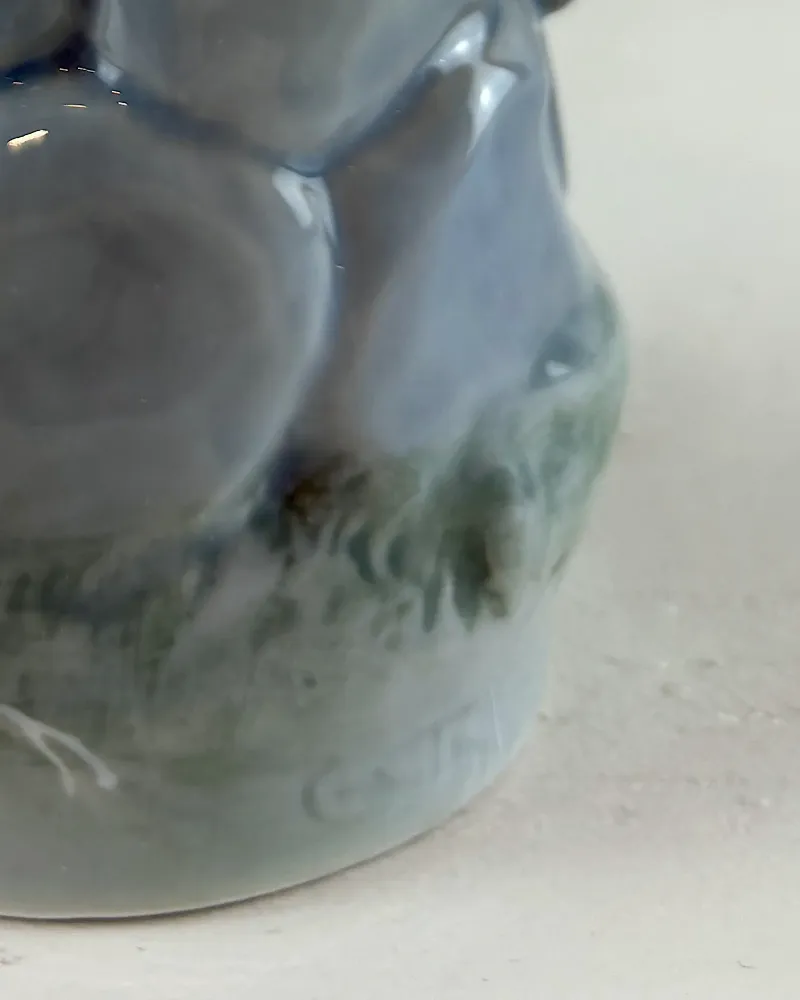 Close-up of the moulded signature at the rear of the base of a Royal Copenhagen boy whittling figurine