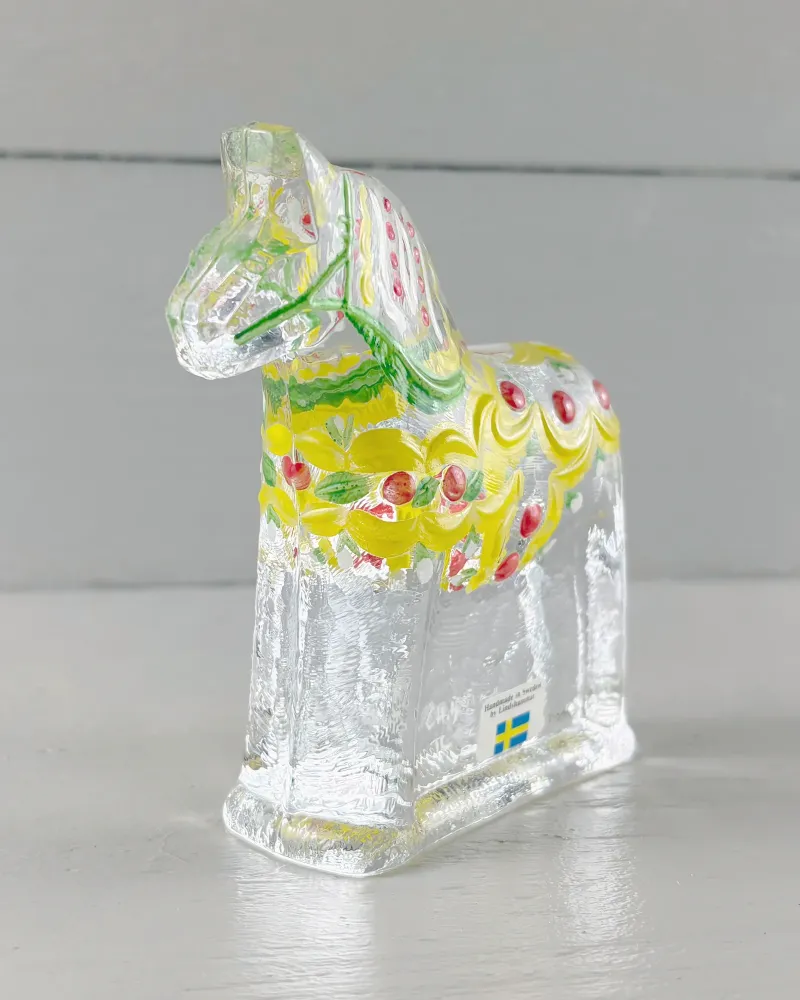 Lindshammar glass Dala horse seen from the front at an angle, showing painted mane and clear glass base