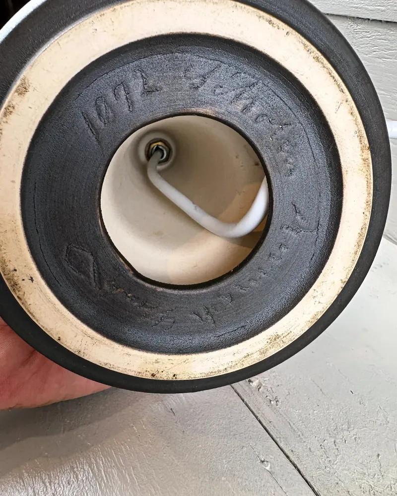 Base of Soholm 1072 stoneware lamp showing unglazed foot ring, cord opening and incised markings