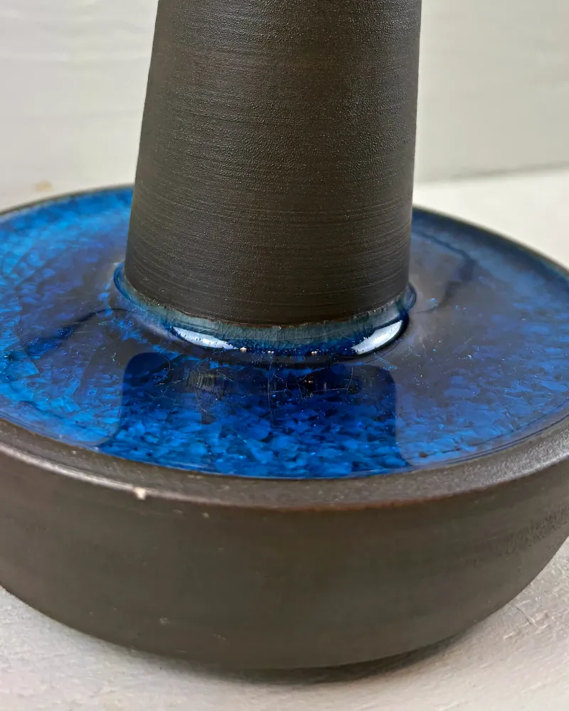 Detail of blue crackle glaze and matte dark stoneware stem of a Danish Soholm table lamp