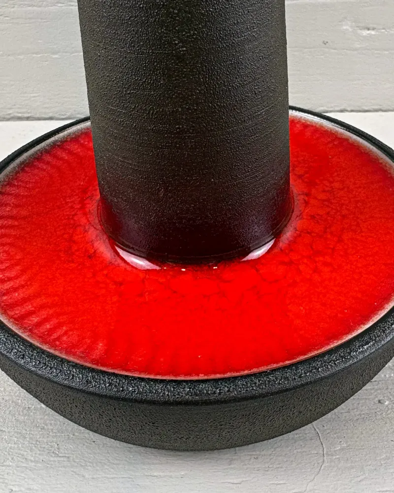 Detail of fine crackle and radial ripples in the red glaze around the stem of a Danish Soholm stoneware lamp