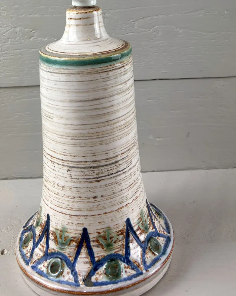 Hand-decorated blue and green band on the flared foot of a Soholm stoneware table lamp