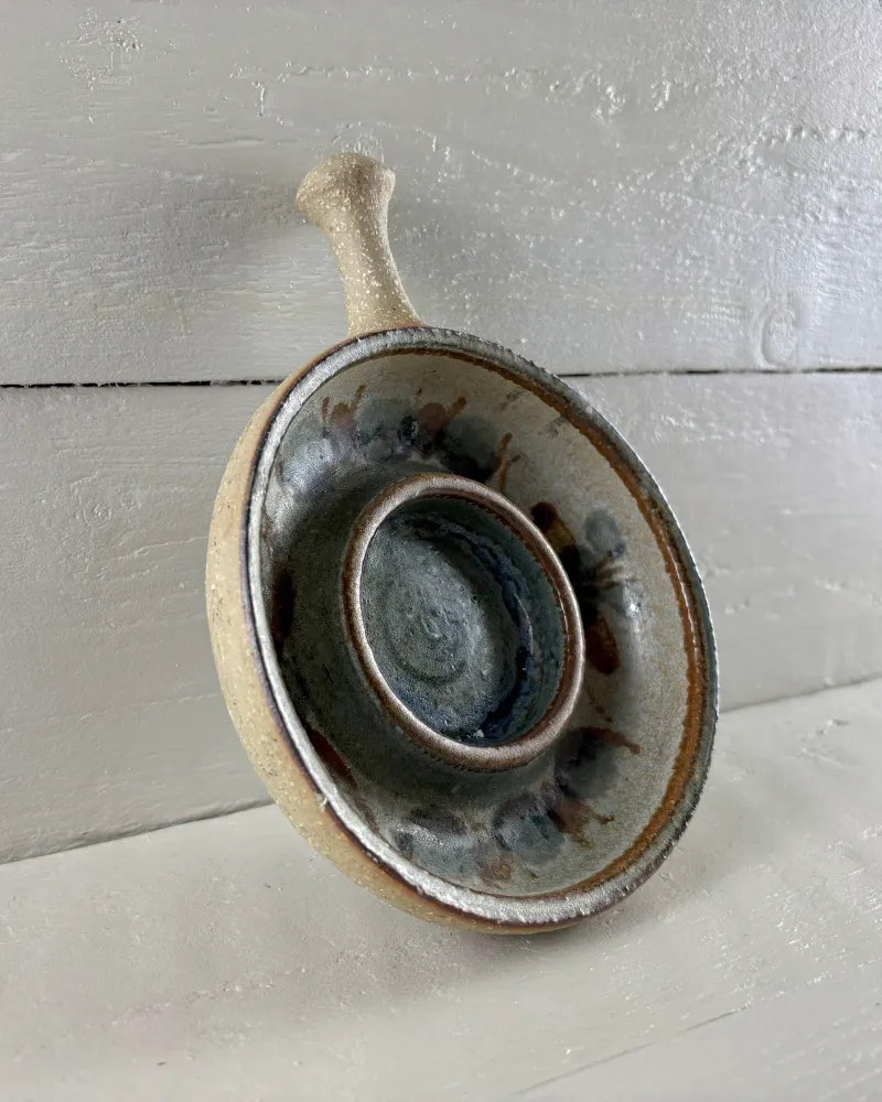 Large Soholm stoneware candle holder with handle, three-quarter view showing the swirled blue glaze