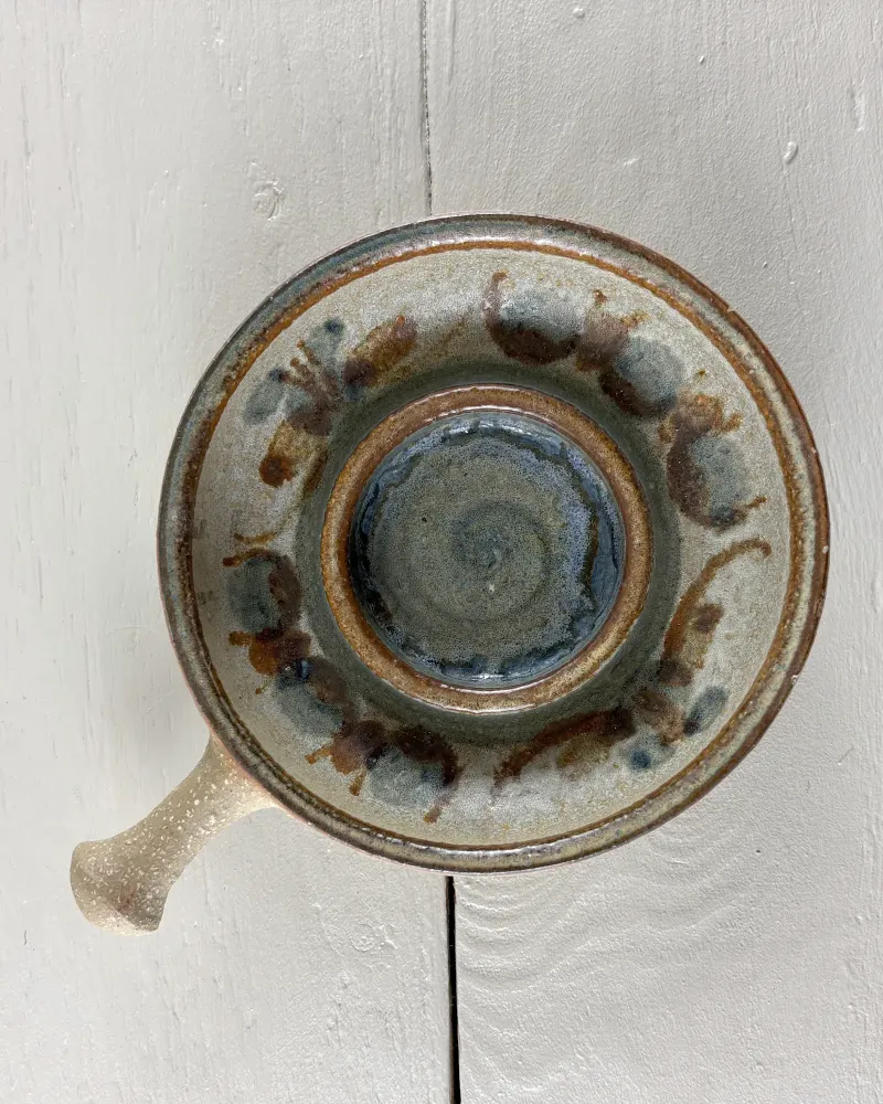 Close-up of the large Soholm candle holder with swirled blue glaze and hand-painted brown and blue motifs