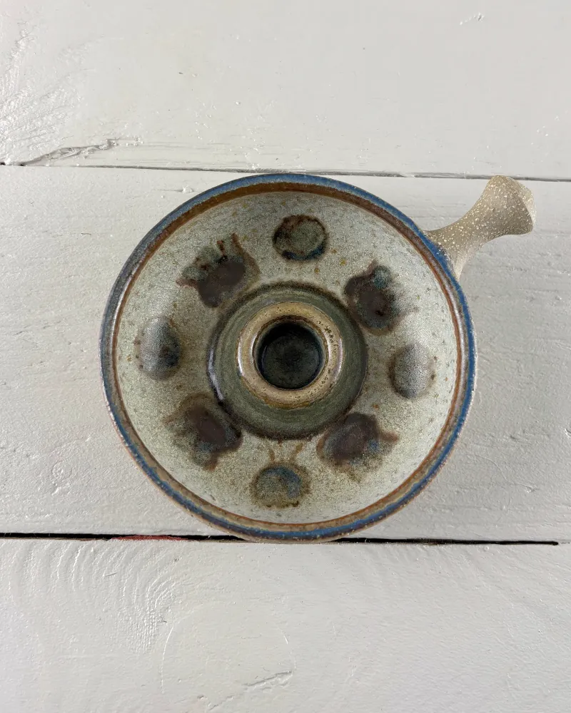Small Soholm candle holder with a blue-edged rim and dark socket, seen from above