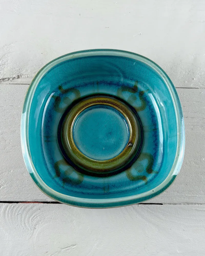 Top view of Soholm bowl 3254 with olive-green centre ring and olive and cobalt glaze spots on the turquoise interior