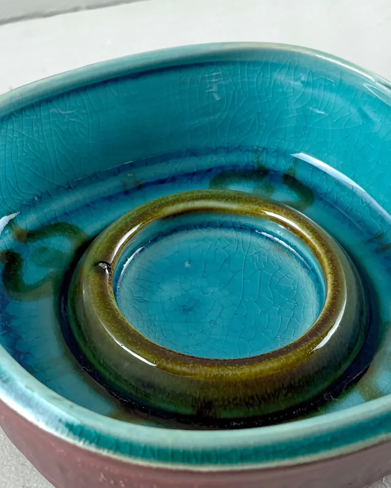 Close-up of turquoise glaze with fine crazing and the raised olive-green ring inside a Soholm stoneware bowl
