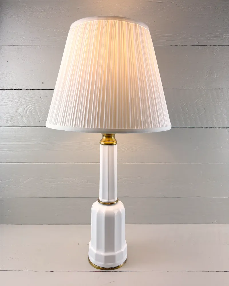 Soholm Heiberg porcelain and brass table lamp switched on, warm light through the illustrative shade
