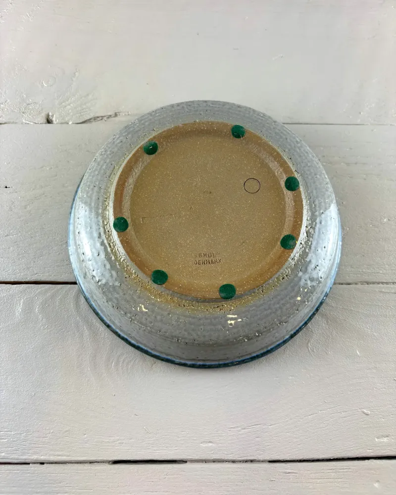 Underside of the Søholm bowl: unglazed speckled base with factory stamp and added green felt pads